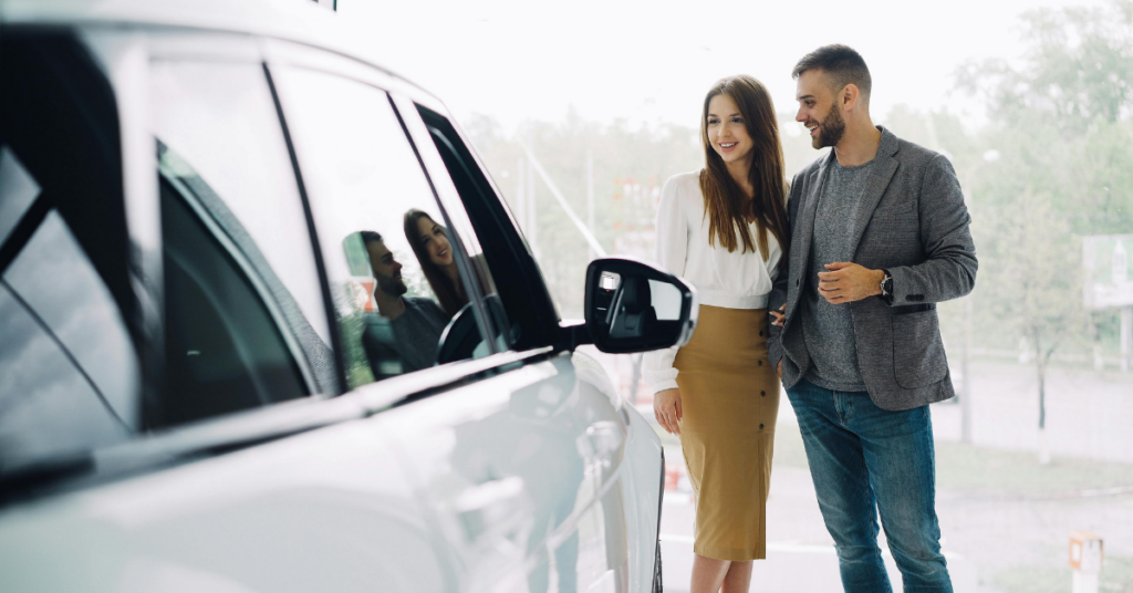 a young couple buying a car with right turn auto