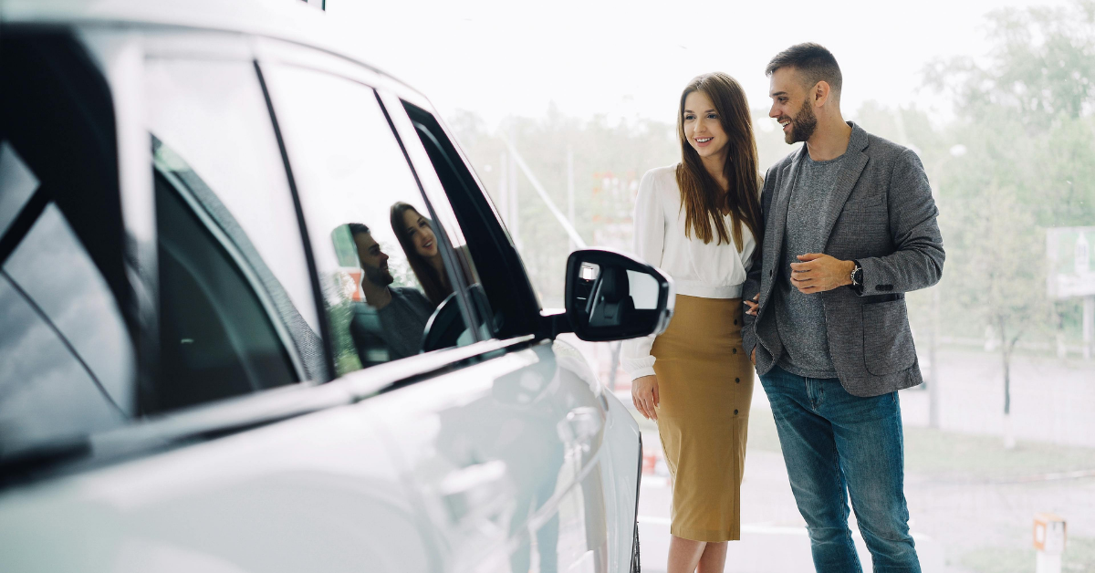a young couple buying a car with right turn auto