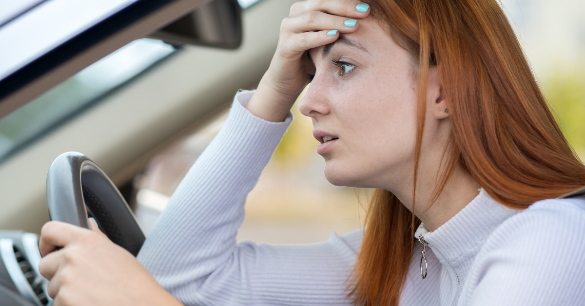 younger woman frustrated with hand on head paying too much for her car loan