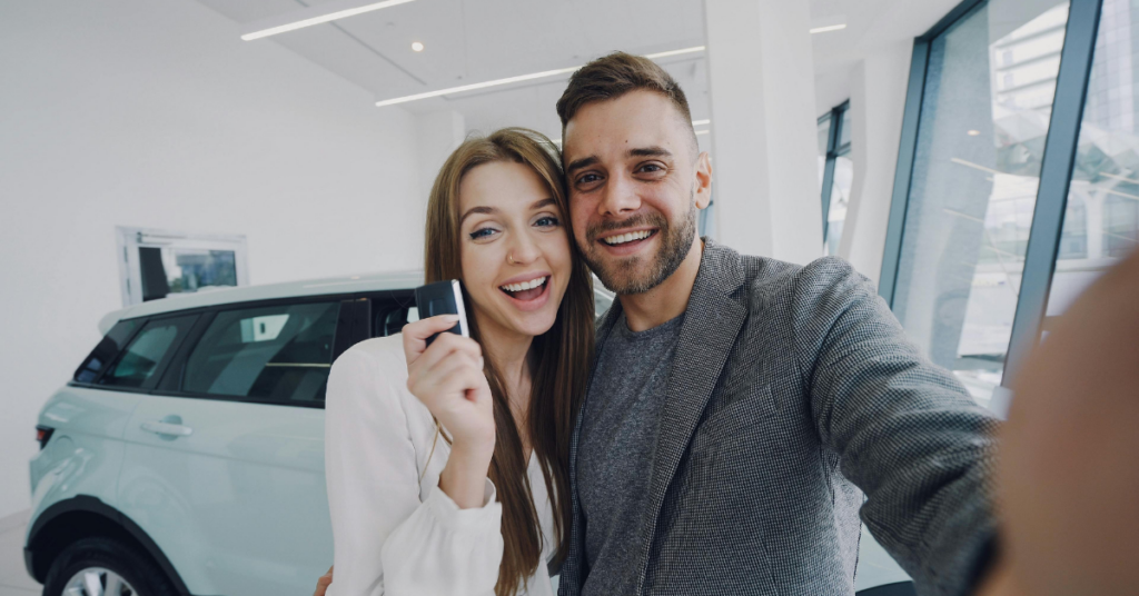 young couple with car key after acquiring a car loan during a consumer proposal