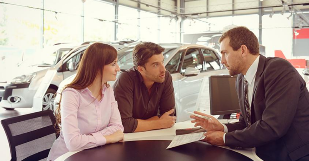 vehicle financing consultation with a young couple
